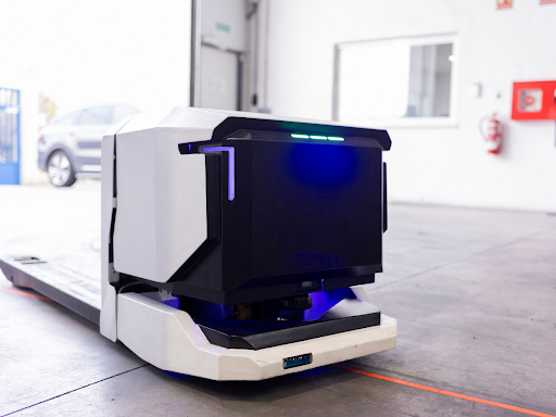 Autonomous mobile robot navigating a manufacturing floor to automate material handling